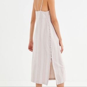 Midi spaghetti strap dress with buttons down the side.